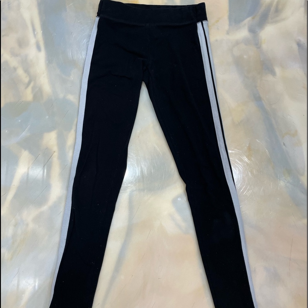 Garage black leggings with 2 white stripes on each side of the leg.